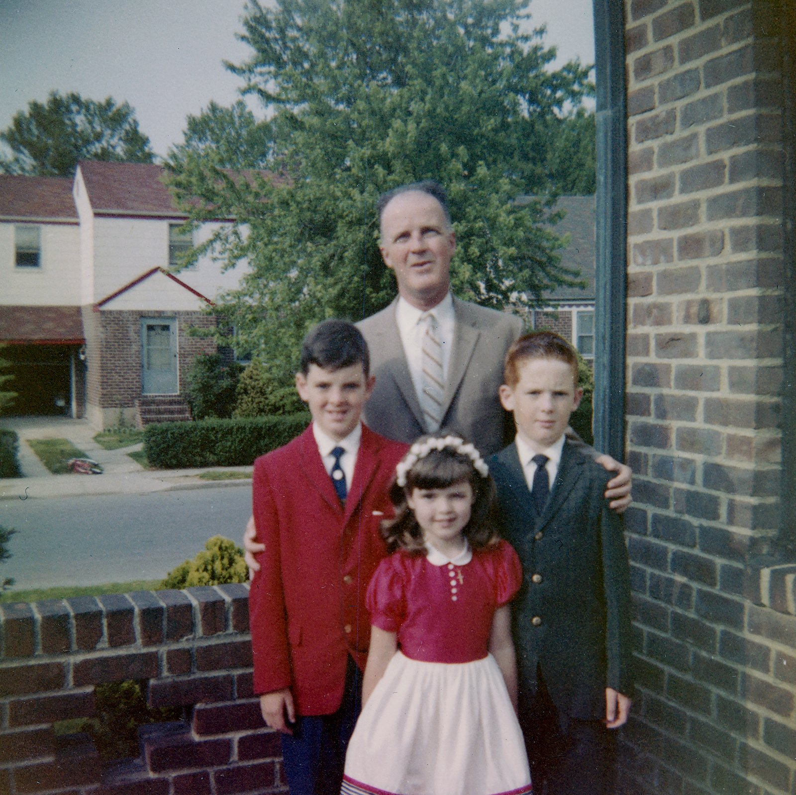 Alice's father William with Alice and her brothers Bill and Kevin (the redhead). Probably taken on the day of Kevin's confirmation. Taken in Elmont, Long Island, New York, probably 1961.