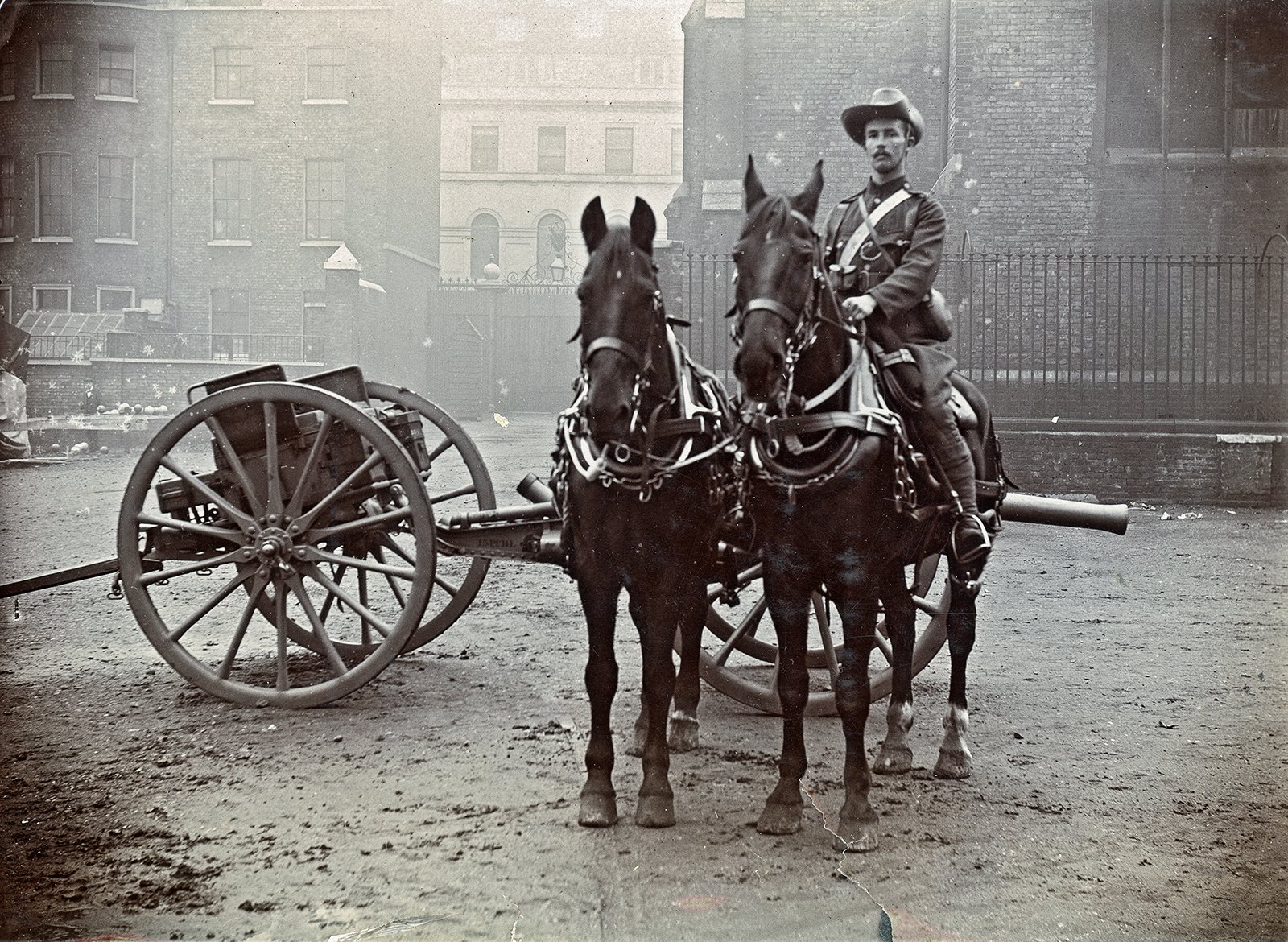 Erskine Childers in his City Imperial Volunteers (CIV) uniform, driving a Battery canon, Adelphi, London, 1899.