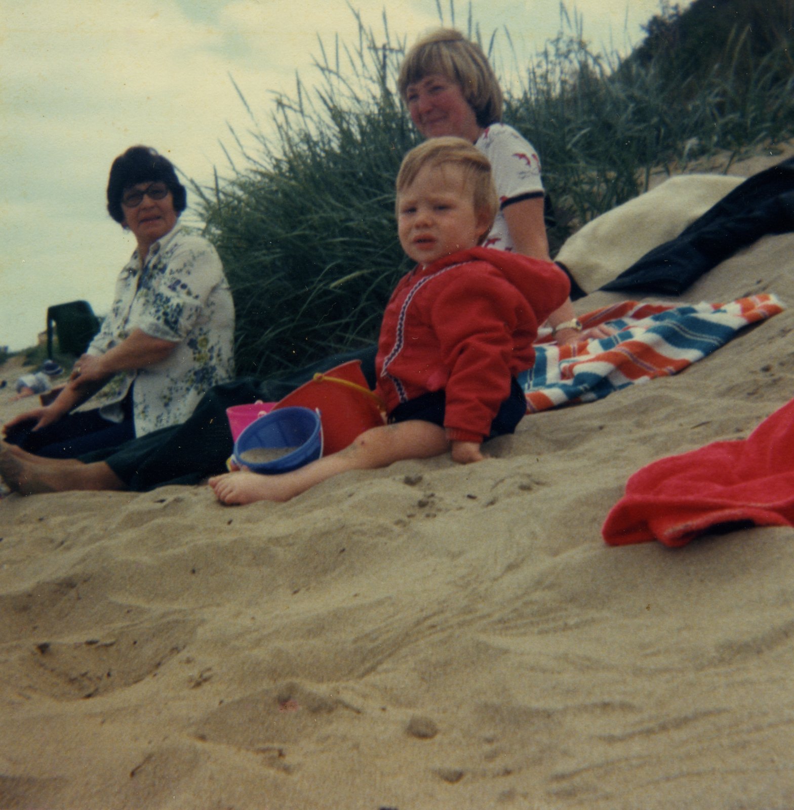 Stewart, the youngest son of Vincent and Marie Campbell, photographed on a beach in Dublin. Marie and Elizabeth, his mother and grandmother, are pictured in the background.