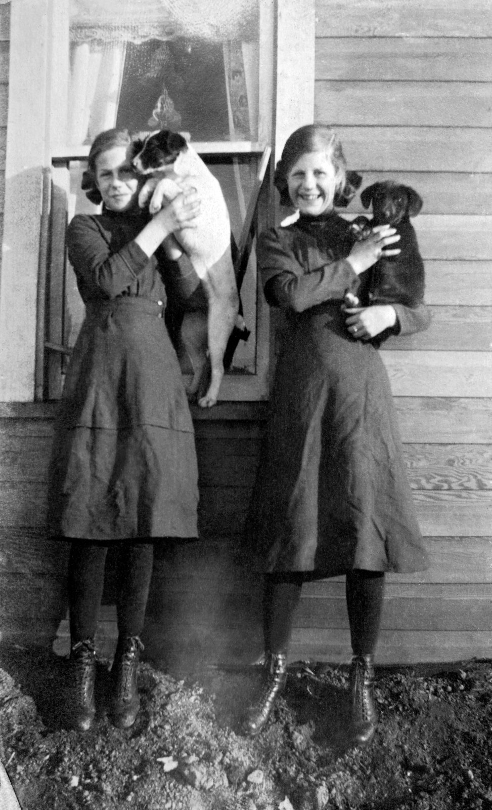 Elliot twin girls with dogs, c.1918.