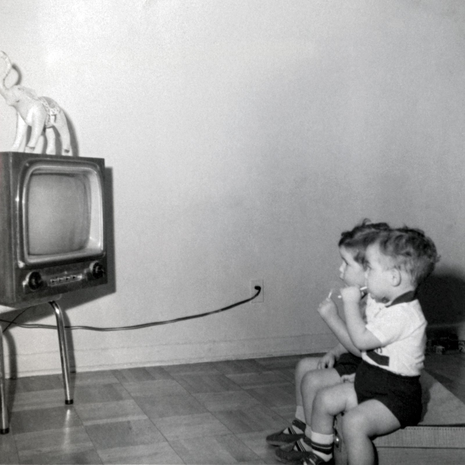 Eoin and Neil, in front of the television, January 1957.